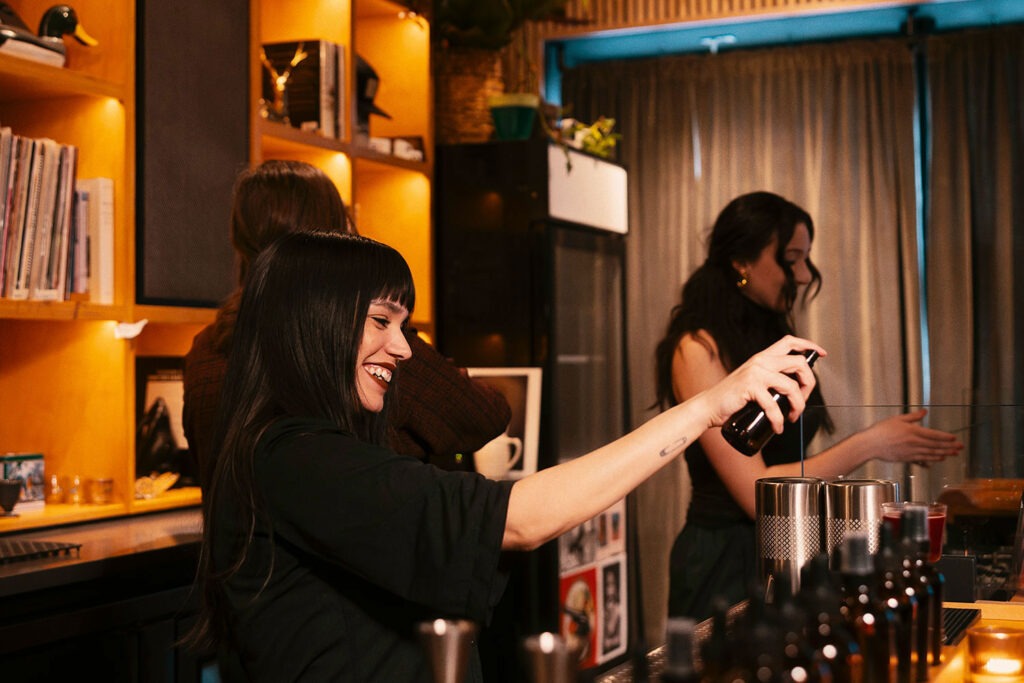 A bartender making a drink at Charis Listening Bar